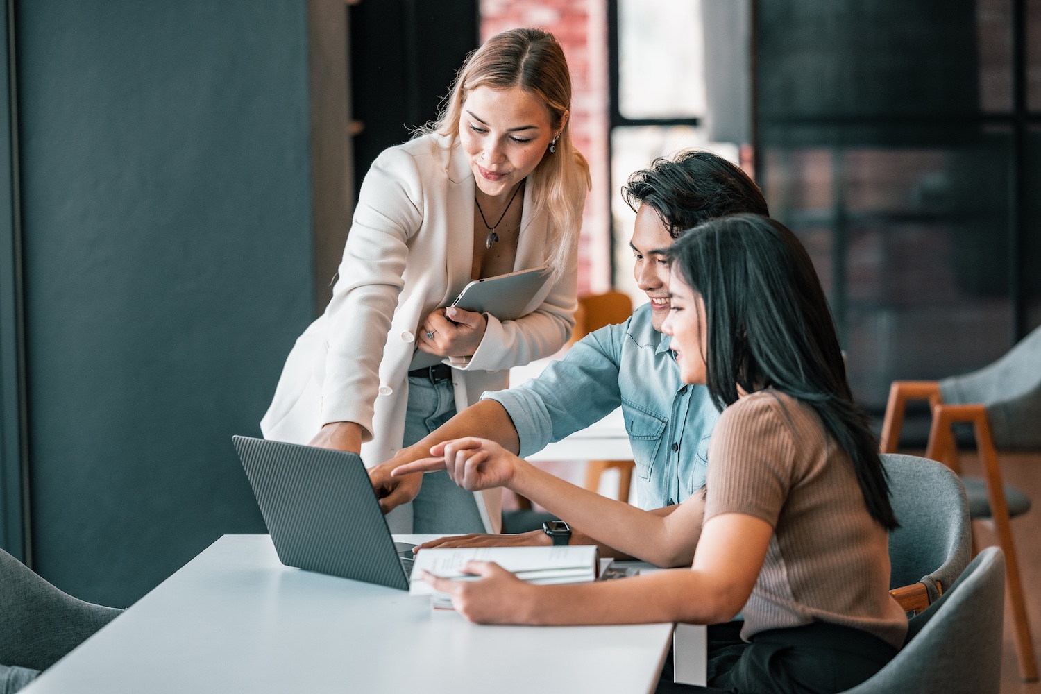 people reviewing information on a laptop